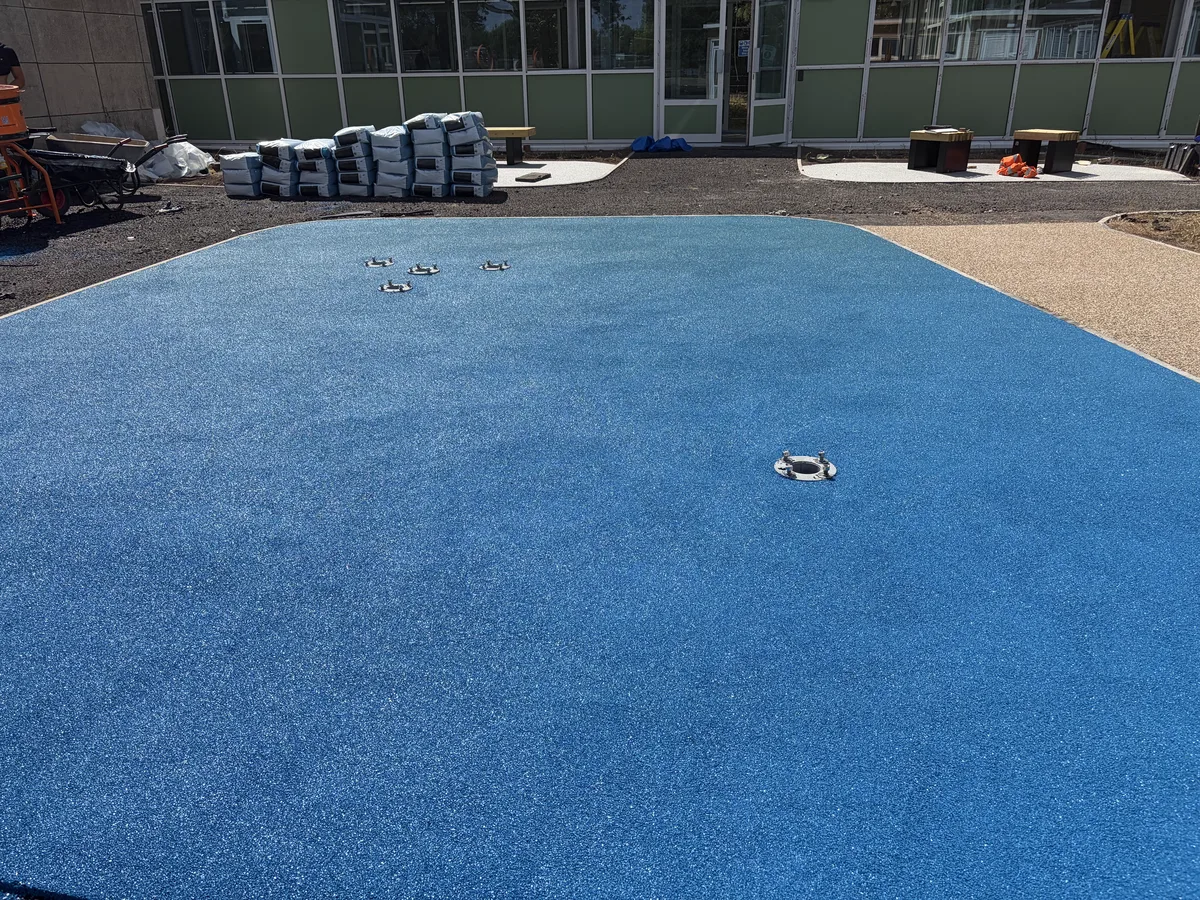 Blue rubber EPDM wet pour safety surfacing laid at a school by A&P Resin