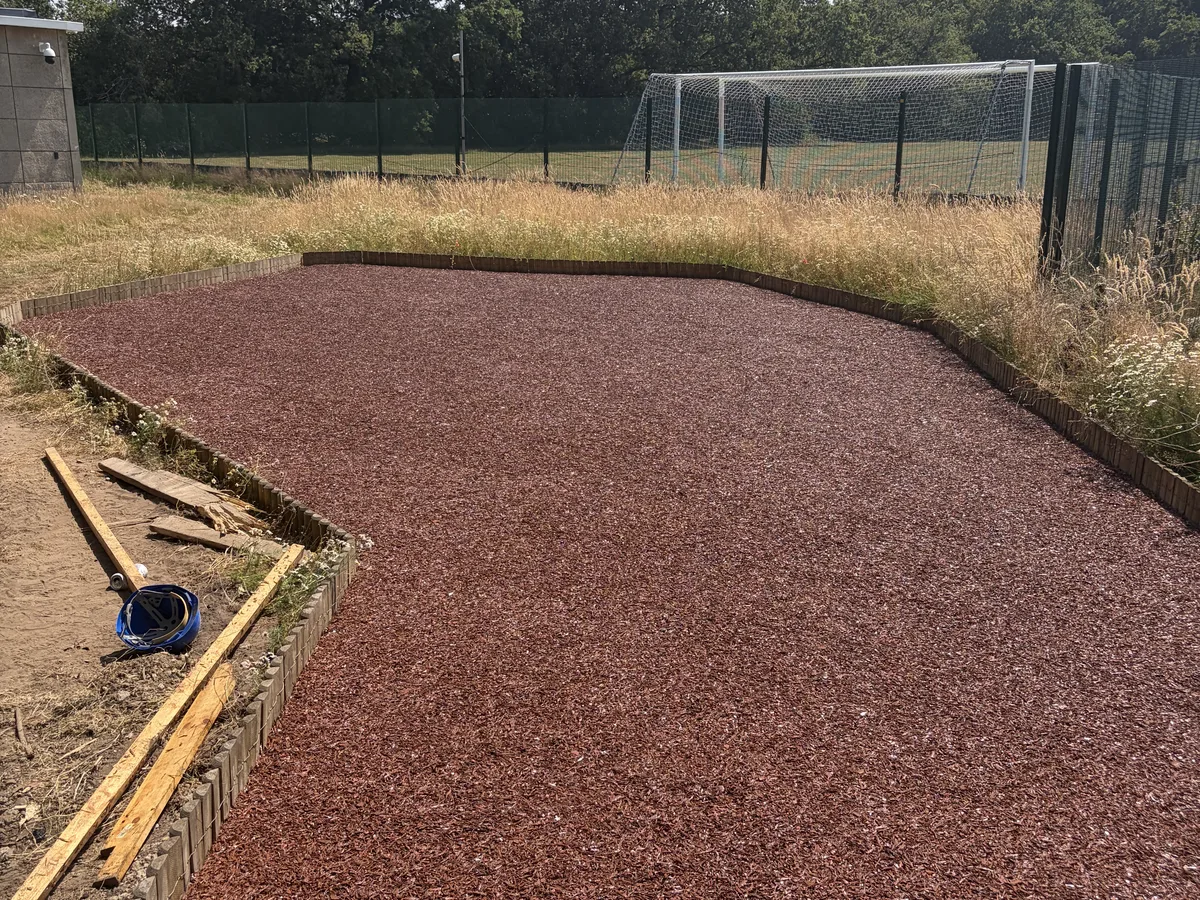 Rubber mulch pathway with a natural bark look, installed by A&P Resin